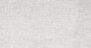 Natural Linen Material Textile Canvas Fabric Texture Background Close-up Detail of Fabric Natural Color Hemp Material Pattern Design Wallpaper. Can be Used as Background or For Graphic Design photo