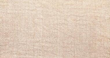 Natural Linen Material Textile Canvas Fabric Texture Background Close-up Detail of Fabric Natural Color Hemp Material Pattern Design Wallpaper. Can be Used as Background or For Graphic Design photo