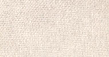 Natural Linen Material Textile Canvas Fabric Texture Background Close-up Detail of Fabric Natural Color Hemp Material Pattern Design Wallpaper. Can be Used as Background or For Graphic Design photo
