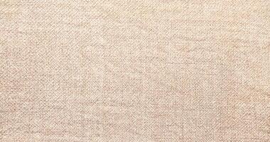 Natural Linen Material Textile Canvas Fabric Texture Background Close-up Detail of Fabric Natural Color Hemp Material Pattern Design Wallpaper. Can be Used as Background or For Graphic Design photo