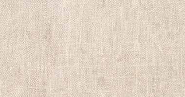 Natural Linen Material Textile Canvas Fabric Texture Background Close-up Detail of Fabric Natural Color Hemp Material Pattern Design Wallpaper. Can be Used as Background or For Graphic Design photo