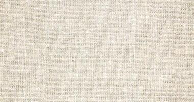 Natural Linen Material Textile Canvas Fabric Texture Background Close-up Detail of Fabric Natural Color Hemp Material Pattern Design Wallpaper. Can be Used as Background or For Graphic Design photo