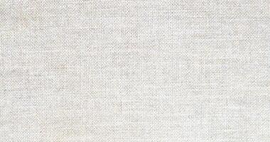 Natural Linen Material Textile Canvas Fabric Texture Background Close-up Detail of Fabric Natural Color Hemp Material Pattern Design Wallpaper. Can be Used as Background or For Graphic Design photo