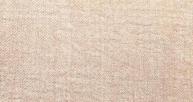 Natural Linen Material Textile Canvas Fabric Texture Background Close-up Detail of Fabric Natural Color Hemp Material Pattern Design Wallpaper. Can be Used as Background or For Graphic Design photo