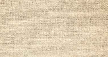 Natural Linen Material Textile Canvas Fabric Texture Background Close-up Detail of Fabric Natural Color Hemp Material Pattern Design Wallpaper. Can be Used as Background or For Graphic Design photo