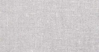 Natural Linen Material Textile Canvas Fabric Texture Background Close-up Detail of Fabric Natural Color Hemp Material Pattern Design Wallpaper. Can be Used as Background or For Graphic Design photo