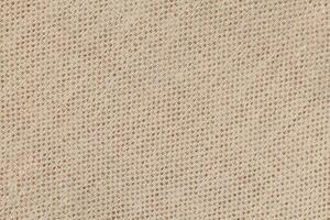 Natural Linen Material Textile Canvas Fabric Texture Background Close-up Detail of Fabric Natural Color Hemp Material Pattern Design Wallpaper. Can be Used as Background or For Graphic Design photo