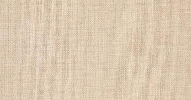 Natural Linen Material Textile Canvas Fabric Texture Background Close-up Detail of Fabric Natural Color Hemp Material Pattern Design Wallpaper. Can be Used as Background or For Graphic Design photo