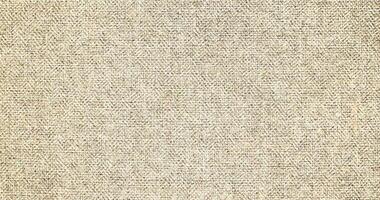 Natural Linen Material Textile Canvas Fabric Texture Background Close-up Detail of Fabric Natural Color Hemp Material Pattern Design Wallpaper. Can be Used as Background or For Graphic Design photo
