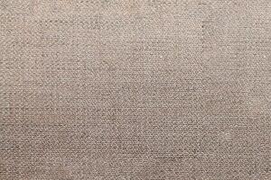 Natural Linen Material Textile Canvas Fabric Texture Background Close-up Detail of Fabric Natural Color Hemp Material Pattern Design Wallpaper. Can be Used as Background or For Graphic Design photo