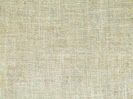 Natural Linen Material Textile Canvas Fabric Texture Background Close-up Detail of Fabric Natural Color Hemp Material Pattern Design Wallpaper. Can be Used as Background or For Graphic Design photo