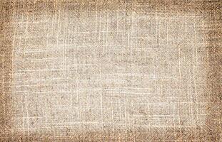 Natural Linen Material Textile Canvas Fabric Texture Background Close-up Detail of Fabric Natural Color Hemp Material Pattern Design Wallpaper. Can be Used as Background or For Graphic Design photo