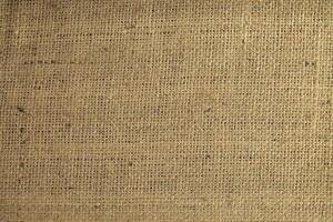Natural Linen Material Textile Canvas Fabric Texture Background Close-up Detail of Fabric Natural Color Hemp Material Pattern Design Wallpaper. Can be Used as Background or For Graphic Design photo