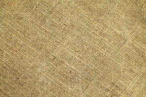 Natural Linen Material Textile Canvas Fabric Texture Background Close-up Detail of Fabric Natural Color Hemp Material Pattern Design Wallpaper. Can be Used as Background or For Graphic Design photo