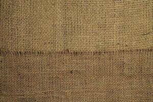 Natural Linen Material Textile Canvas Fabric Texture Background Close-up Detail of Fabric Natural Color Hemp Material Pattern Design Wallpaper. Can be Used as Background or For Graphic Design photo