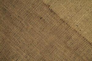 Natural Linen Material Textile Canvas Fabric Texture Background Close-up Detail of Fabric Natural Color Hemp Material Pattern Design Wallpaper. Can be Used as Background or For Graphic Design photo
