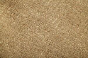 Natural Linen Material Textile Canvas Fabric Texture Background Close-up Detail of Fabric Natural Color Hemp Material Pattern Design Wallpaper. Can be Used as Background or For Graphic Design photo