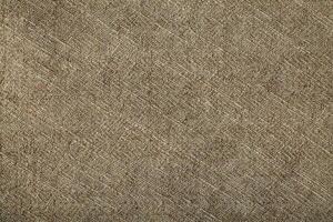 Natural Linen Material Textile Canvas Fabric Texture Background Close-up Detail of Fabric Natural Color Hemp Material Pattern Design Wallpaper. Can be Used as Background or For Graphic Design photo
