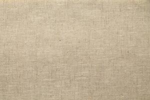 Natural Linen Material Textile Canvas Fabric Texture Background Close-up Detail of Fabric Natural Color Hemp Material Pattern Design Wallpaper. Can be Used as Background or For Graphic Design photo