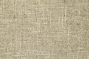 Natural Linen Material Textile Canvas Fabric Texture Background Close-up Detail of Fabric Natural Color Hemp Material Pattern Design Wallpaper. Can be Used as Background or For Graphic Design photo