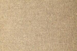 Natural Linen Material Textile Canvas Fabric Texture Background Close-up Detail of Fabric Natural Color Hemp Material Pattern Design Wallpaper. Can be Used as Background or For Graphic Design photo