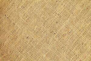 Natural Linen Material Textile Canvas Fabric Texture Background Close-up Detail of Fabric Natural Color Hemp Material Pattern Design Wallpaper. Can be Used as Background or For Graphic Design photo