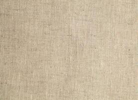 Natural Linen Material Textile Canvas Fabric Texture Background Close-up Detail of Fabric Natural Color Hemp Material Pattern Design Wallpaper. Can be Used as Background or For Graphic Design photo