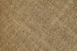 Natural Linen Material Textile Canvas Fabric Texture Background Close-up Detail of Fabric Natural Color Hemp Material Pattern Design Wallpaper. Can be Used as Background or For Graphic Design photo