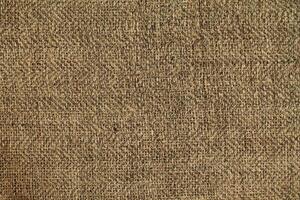 Natural Linen Material Textile Canvas Fabric Texture Background Close-up Detail of Fabric Natural Color Hemp Material Pattern Design Wallpaper. Can be Used as Background or For Graphic Design photo
