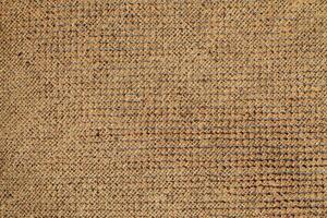 Natural Linen Material Textile Canvas Fabric Texture Background Close-up Detail of Fabric Natural Color Hemp Material Pattern Design Wallpaper. Can be Used as Background or For Graphic Design photo