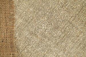 Natural Linen Material Textile Canvas Fabric Texture Background Close-up Detail of Fabric Natural Color Hemp Material Pattern Design Wallpaper. Can be Used as Background or For Graphic Design photo