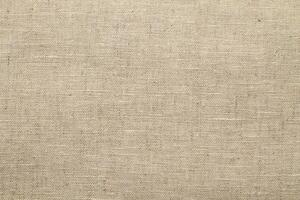Natural Linen Material Textile Canvas Fabric Texture Background Close-up Detail of Fabric Natural Color Hemp Material Pattern Design Wallpaper. Can be Used as Background or For Graphic Design photo