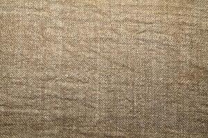 Natural Linen Material Textile Canvas Fabric Texture Background Close-up Detail of Fabric Natural Color Hemp Material Pattern Design Wallpaper. Can be Used as Background or For Graphic Design photo