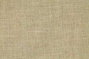 Natural Linen Material Textile Canvas Fabric Texture Background Close-up Detail of Fabric Natural Color Hemp Material Pattern Design Wallpaper. Can be Used as Background or For Graphic Design photo