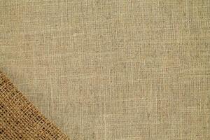 Natural Linen Material Textile Canvas Fabric Texture Background Close-up Detail of Fabric Natural Color Hemp Material Pattern Design Wallpaper. Can be Used as Background or For Graphic Design photo