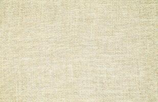 Natural Linen Material Textile Canvas Fabric Texture Background Close-up Detail of Fabric Natural Color Hemp Material Pattern Design Wallpaper. Can be Used as Background or For Graphic Design photo