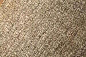 Natural Linen Material Textile Canvas Fabric Texture Background Close-up Detail of Fabric Natural Color Hemp Material Pattern Design Wallpaper. Can be Used as Background or For Graphic Design photo
