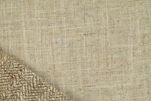Natural Linen Material Textile Canvas Fabric Texture Background Close-up Detail of Fabric Natural Color Hemp Material Pattern Design Wallpaper. Can be Used as Background or For Graphic Design photo