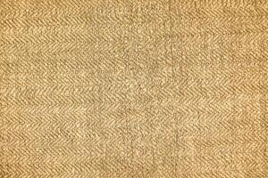 Natural Linen Material Textile Canvas Fabric Texture Background Close-up Detail of Fabric Natural Color Hemp Material Pattern Design Wallpaper. Can be Used as Background or For Graphic Design photo