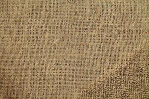 Natural Linen Material Textile Canvas Fabric Texture Background Close-up Detail of Fabric Natural Color Hemp Material Pattern Design Wallpaper. Can be Used as Background or For Graphic Design photo