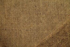 Natural Linen Material Textile Canvas Fabric Texture Background Close-up Detail of Fabric Natural Color Hemp Material Pattern Design Wallpaper. Can be Used as Background or For Graphic Design photo