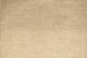 Natural Linen Material Textile Canvas Fabric Texture Background Close-up Detail of Fabric Natural Color Hemp Material Pattern Design Wallpaper. Can be Used as Background or For Graphic Design photo