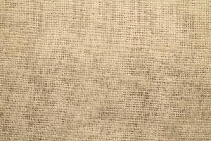 Natural Linen Material Textile Canvas Fabric Texture Background Close-up Detail of Fabric Natural Color Hemp Material Pattern Design Wallpaper. Can be Used as Background or For Graphic Design photo