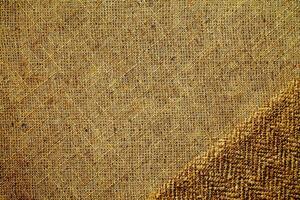 Natural Linen Material Textile Canvas Fabric Texture Background Close-up Detail of Fabric Natural Color Hemp Material Pattern Design Wallpaper. Can be Used as Background or For Graphic Design photo