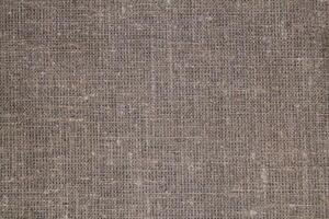 Natural Linen Material Textile Canvas Fabric Texture Background Close-up Detail of Fabric Natural Color Hemp Material Pattern Design Wallpaper. Can be Used as Background or For Graphic Design photo