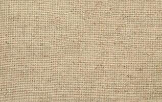 Natural Linen Material Textile Canvas Fabric Texture Background Close-up Detail of Fabric Natural Color Hemp Material Pattern Design Wallpaper. Can be Used as Background or For Graphic Design photo