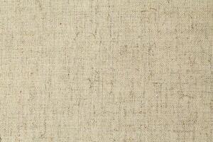 Natural Linen Material Textile Canvas Fabric Texture Background Close-up Detail of Fabric Natural Color Hemp Material Pattern Design Wallpaper. Can be Used as Background or For Graphic Design photo