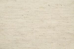 Natural Linen Material Textile Canvas Fabric Texture Background Close-up Detail of Fabric Natural Color Hemp Material Pattern Design Wallpaper. Can be Used as Background or For Graphic Design photo