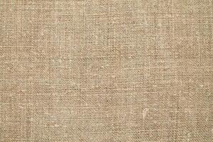 Natural Linen Material Textile Canvas Fabric Texture Background Close-up Detail of Fabric Natural Color Hemp Material Pattern Design Wallpaper. Can be Used as Background or For Graphic Design photo