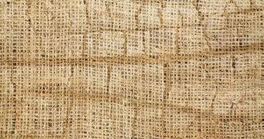 Natural Linen Material Textile Canvas Fabric Texture Background Close-up Detail of Fabric Natural Color Hemp Material Pattern Design Wallpaper. Can be Used as Background or For Graphic Design photo